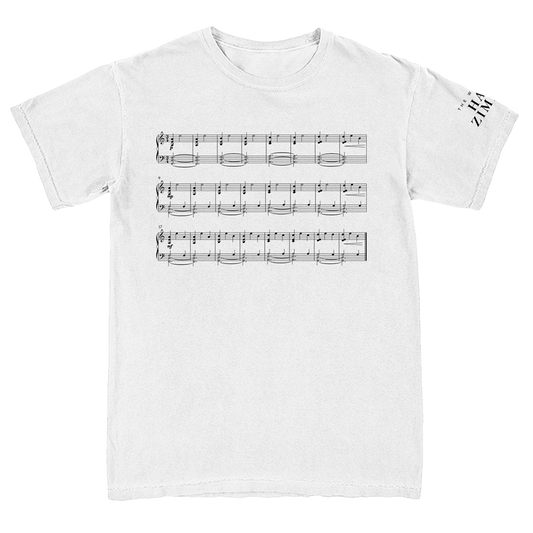White t-shirt with black musical notes design on a white background